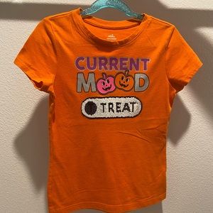 An orange Halloween shirt for a girl.